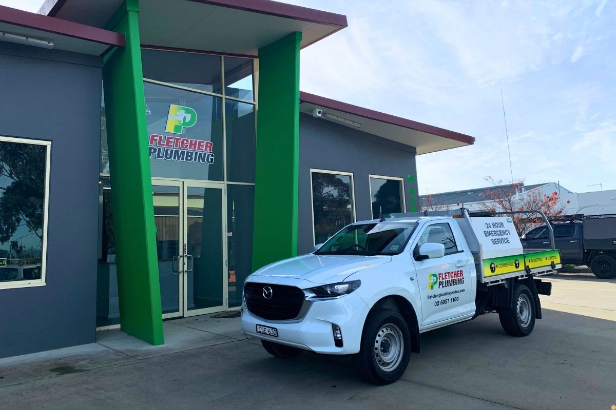 Fletcher Plumbing service ute parked outside the Fletcher Plumbing office in Albury Wodonga, promoting 24 hour emergency plumbing services.